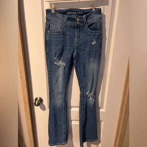 Gemma Rae sz 3/26  flare jeans with factory holes and embellished pockets.